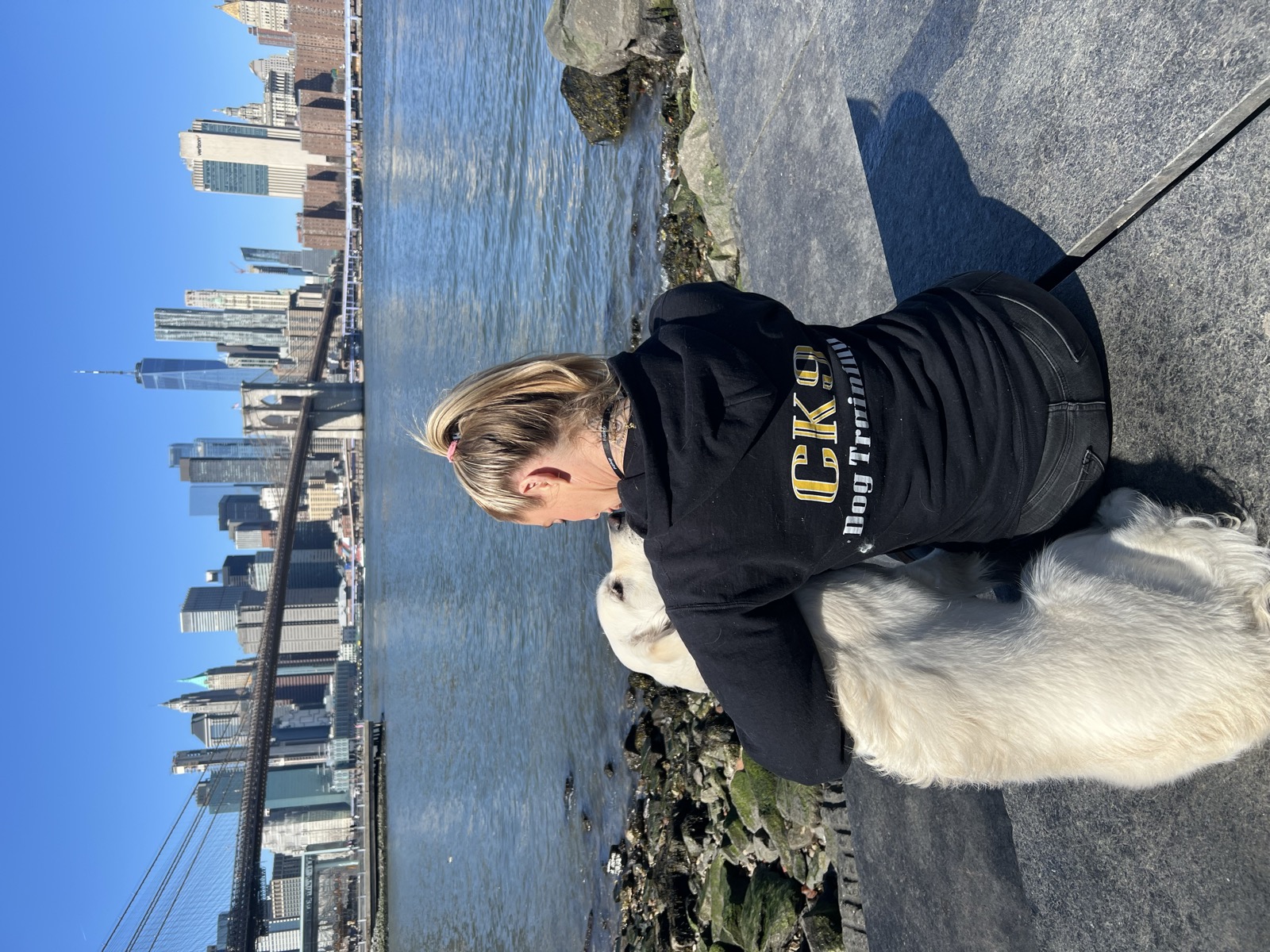 CK9 Standard dog trainer with dog at NYC waterfront overlooking the skyline